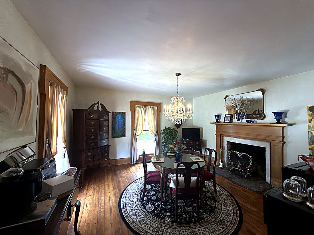 The Parlour — fireplace, chandelier, and breakfast setup